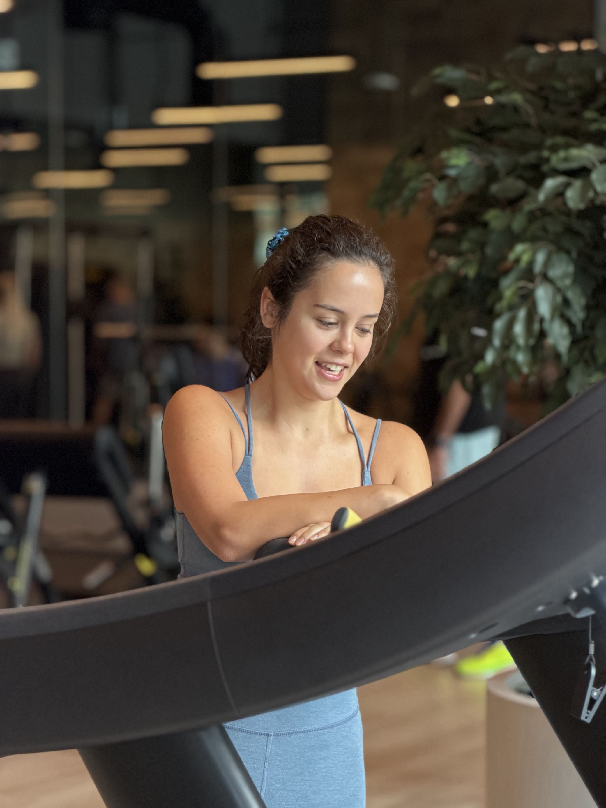 Client smiling between treadmill intervals in the studio