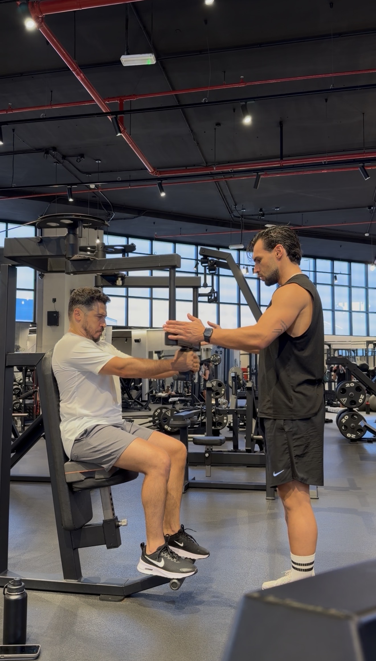Carlos Lomba coaching a client in a Dubai gym